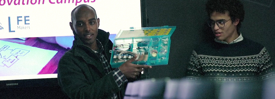 A student holding a small box