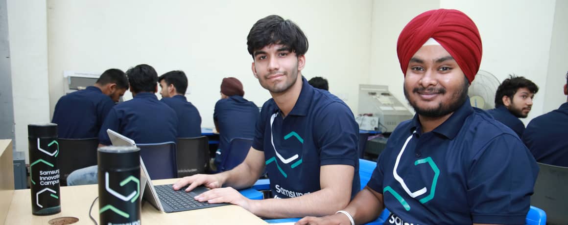 Two students smiling while team working