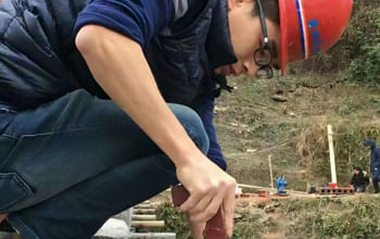 A young man building a bridge