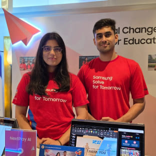 Aadish Abhijeet Shelke and Bhagyashri Heeralal Meena, co-founders of NextPlayAI, are being photographed at the company’s exhibition booth.