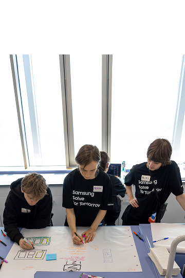 Students participating in Samsung Solve for Tomorrow are demonstrating their projects in front of judges.